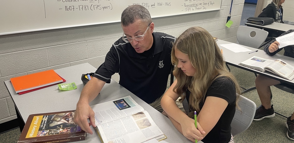 Teacher Assisting Student