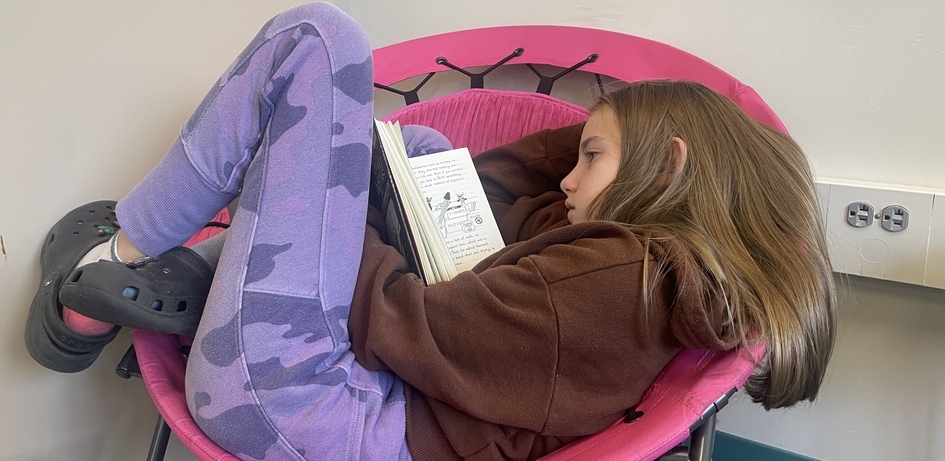 Student Reading In Lazy Chair