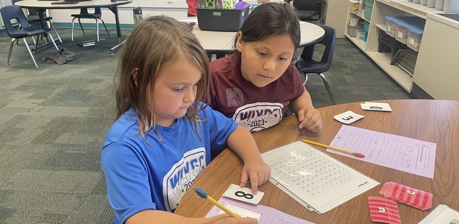 Students Looking at Number Card